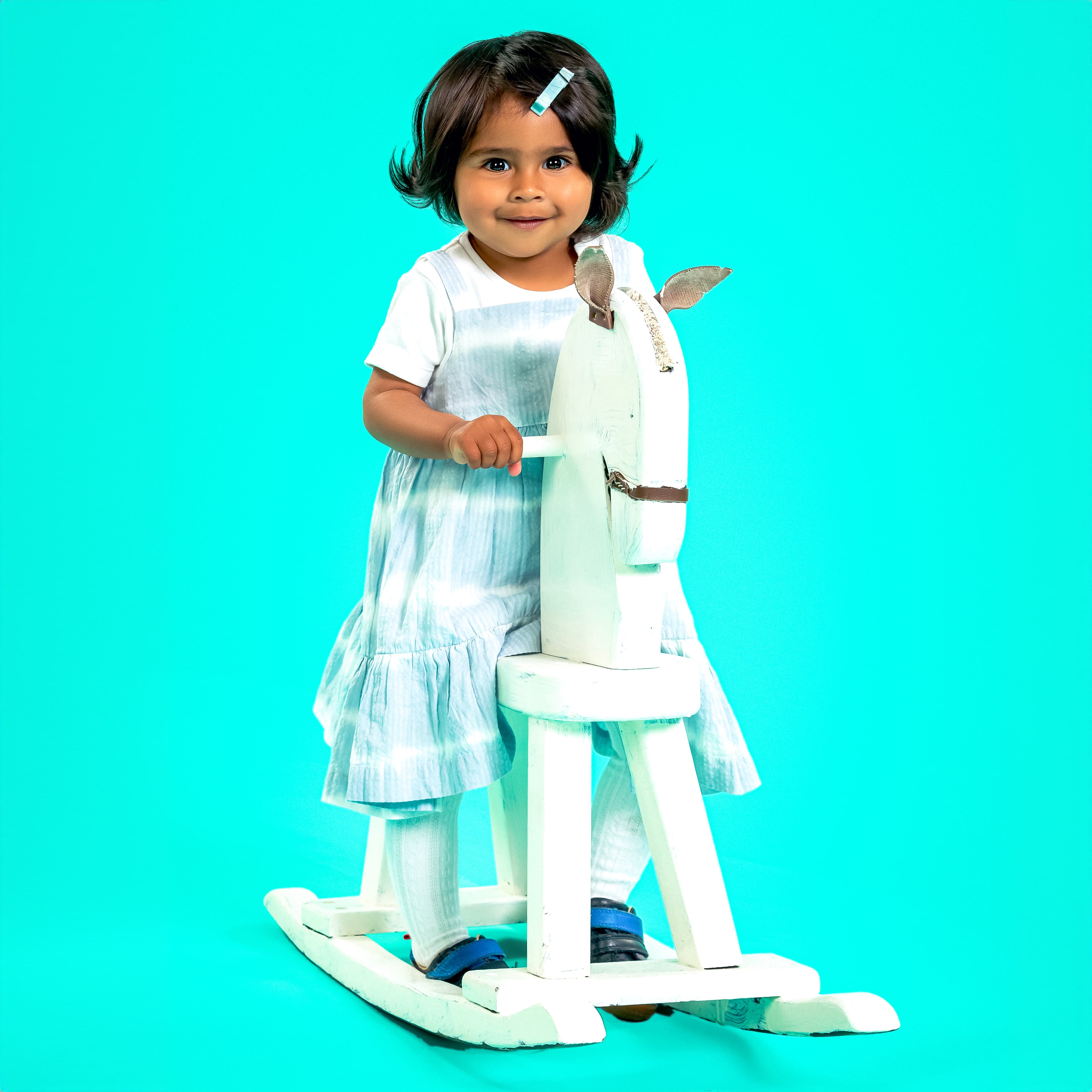 Toddler girl with rocking horse